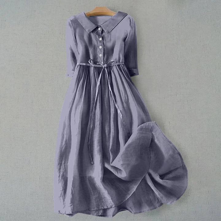 Woman wearing a comfortable short sleeve A-line midi dress, perfect for casual spring & summer outings.