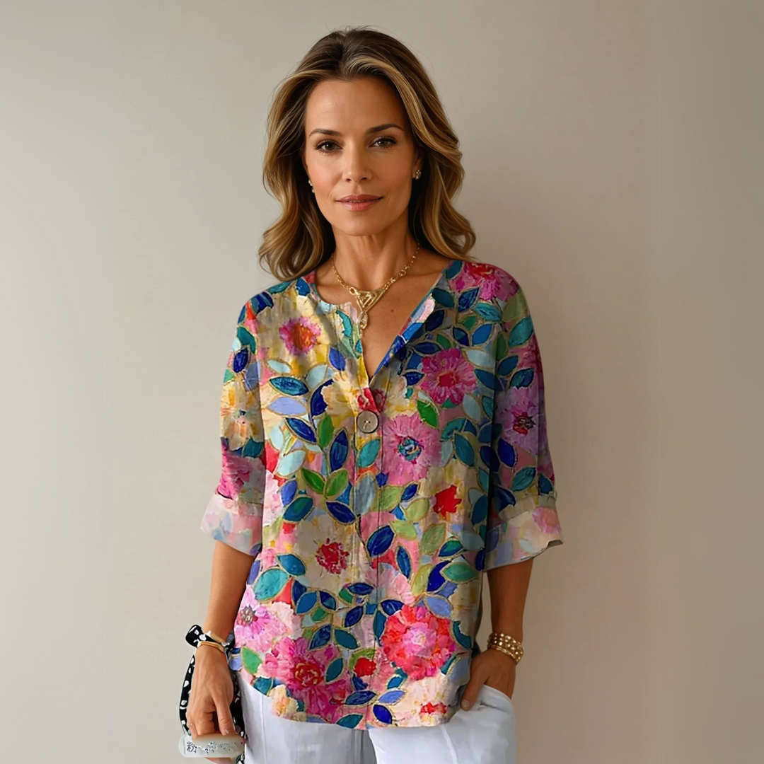 Women's abstract floral V-neck blouse, relaxed fit summer top. Elegant casual fashion with 3/4 sleeves.