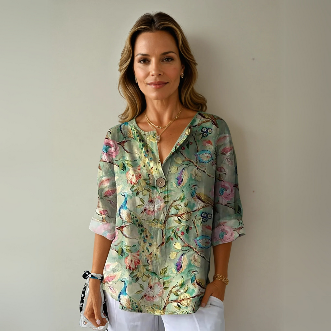 Relaxed women's summer top, abstract floral print V-neck blouse. Versatile for elegant casual warm weather fashion.