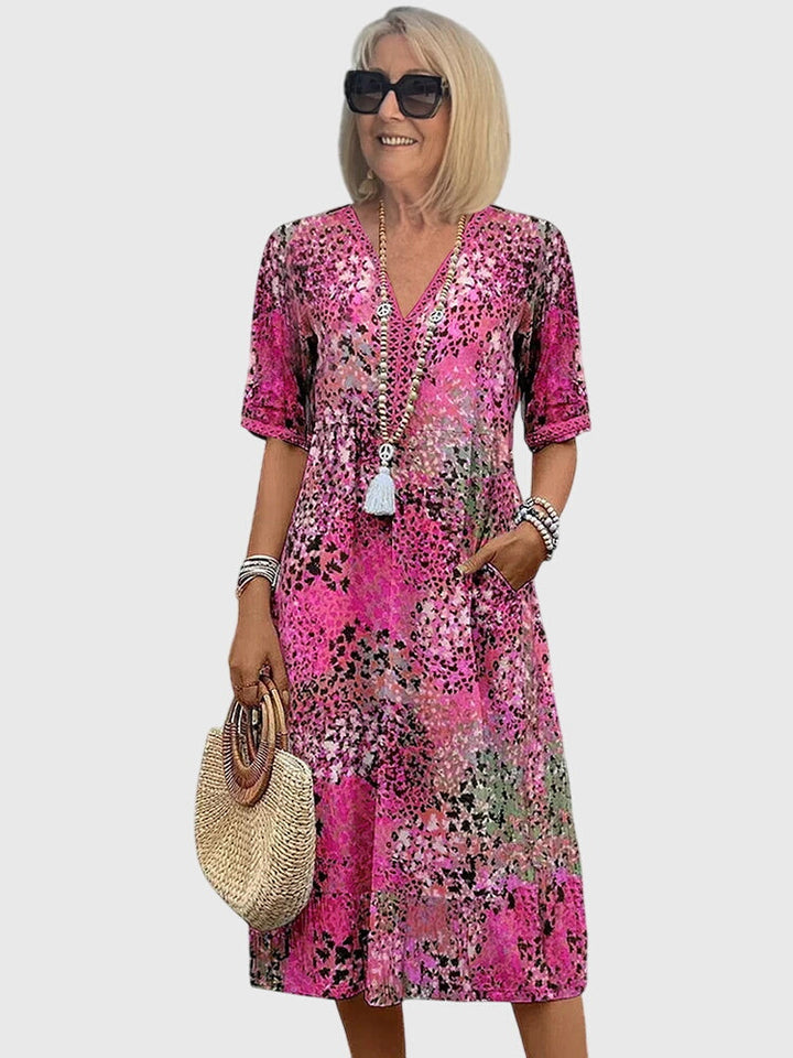 Casual women's abstract print boho midi dress with V-neck, flutter sleeves, ideal for summer fashion.