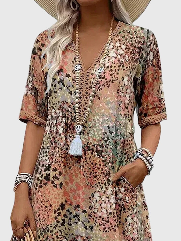 Comfortable women's boho midi summer dress with abstract print, V-neck, and flutter sleeves for relaxed wear.