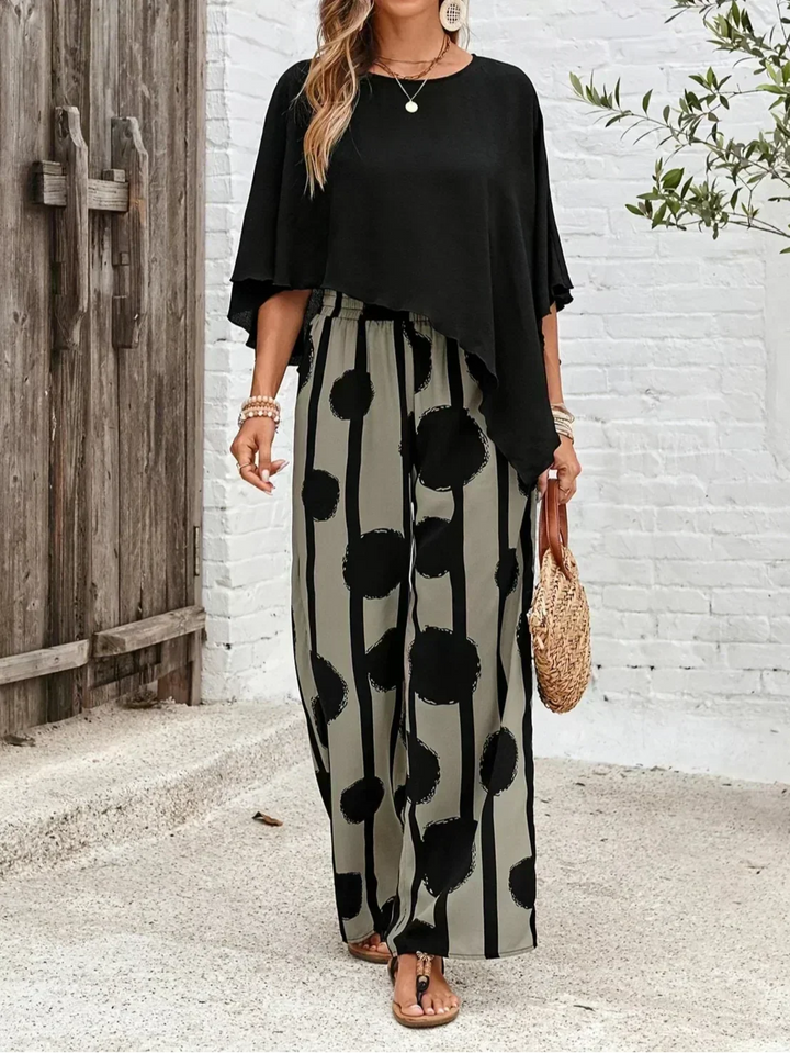 Trendy women's abstract print wide leg trouser and batwing top set, versatile casual outfit.