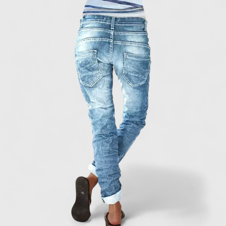 Fashionable women's acid wash skinny jeans, featuring a trendy button fly & contrast stitching.