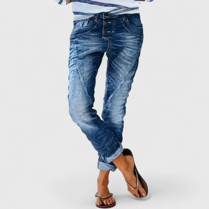 Stylish women's acid wash skinny jeans, high-waisted with a unique button fly and vintage aesthetic.