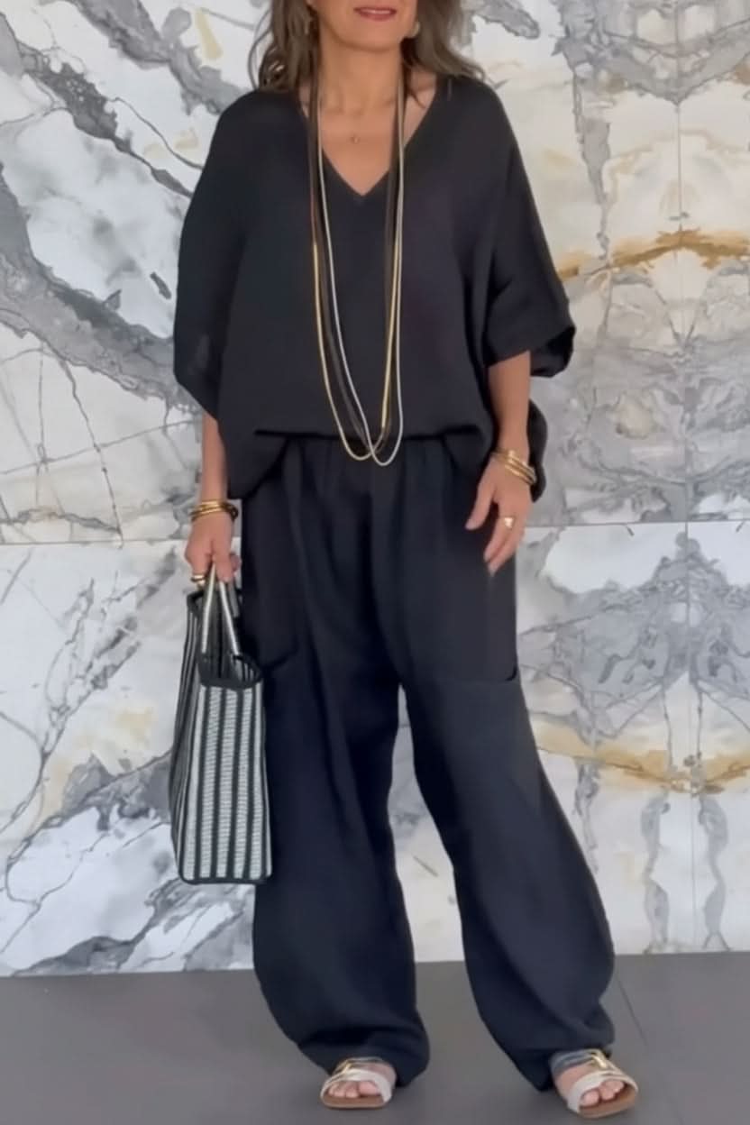 Elegant women's open-back pantsuit set with matching top & wide-leg pants for modern summer wear.