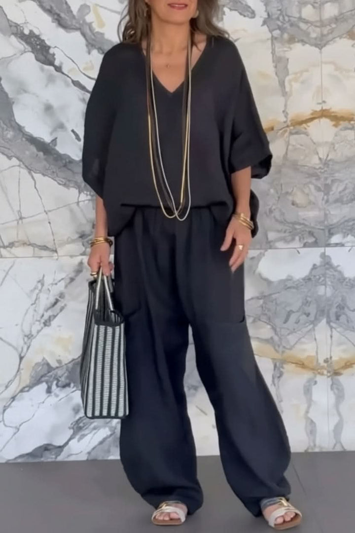 Elegant women's open-back pantsuit set with matching top & wide-leg pants for modern summer wear.