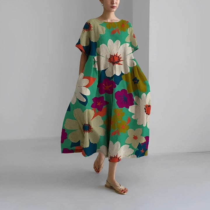 Women's artistic print flowy midi dress with a relaxed fit and practical pockets for summer.