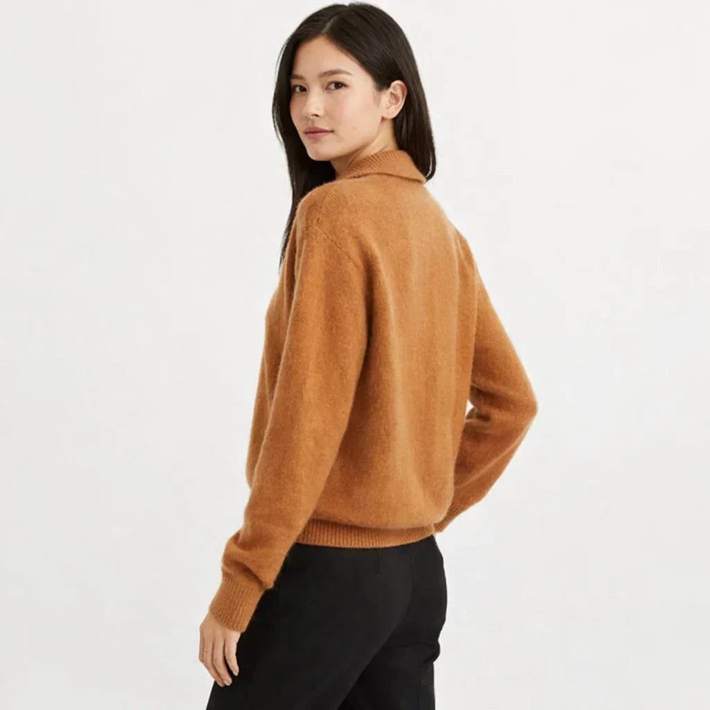 Cozy women's knit cardigan, asymmetrical design, and relaxed fit. Ideal winter layering piece.