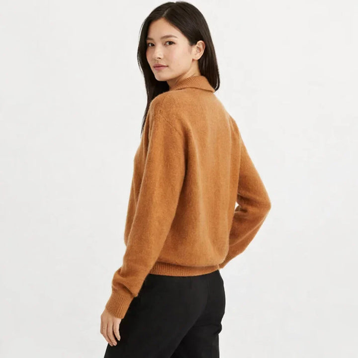 Cozy women's knit cardigan, asymmetrical design, and relaxed fit. Ideal winter layering piece.