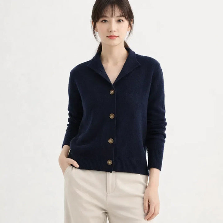 Women's high neck asymmetrical knit cardigan. A warm button placket layering piece for winter style.
