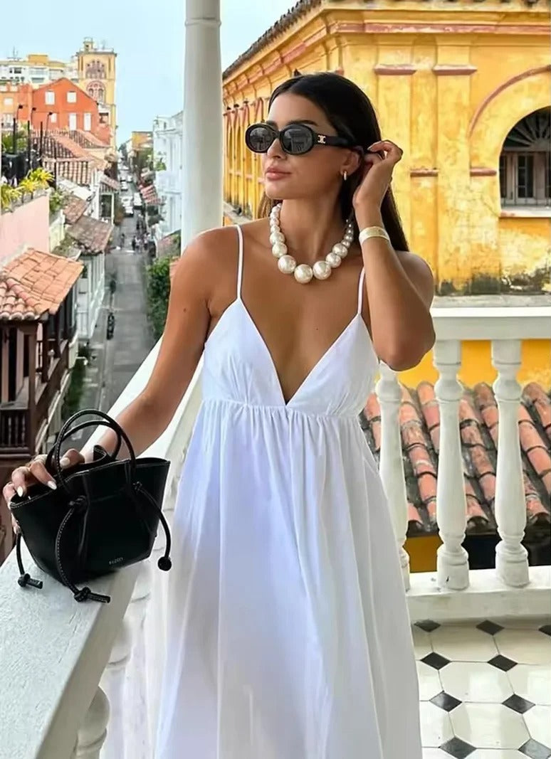 Women's backless spaghetti strap maxi summer dress. Flowy v-neck beach casual dress, perfect for vacation.