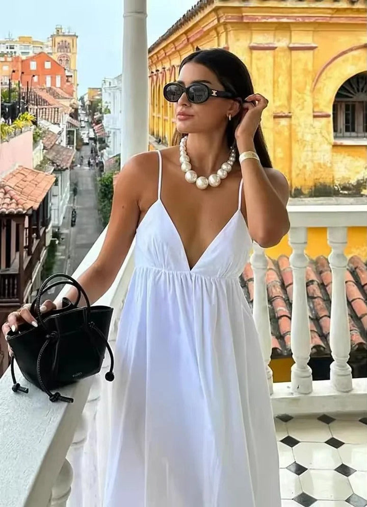 Women's backless spaghetti strap maxi summer dress. Flowy v-neck beach casual dress, perfect for vacation.