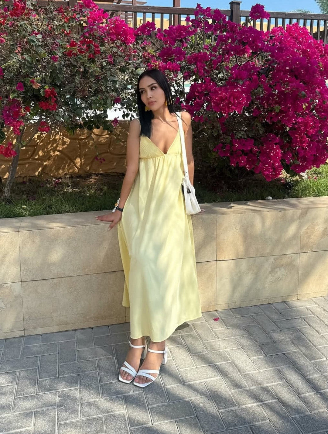 Yellow backless spaghetti strap maxi summer dress. Sleeveless v-neck flowy beachwear for women's vacation.