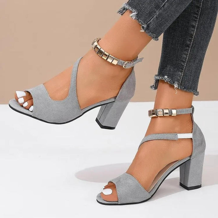 Fashionable women's elegant sandals with a comfortable block heel and ornate beaded ankle strap.