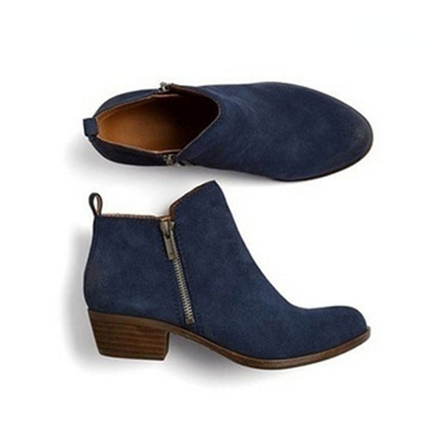 Comfortable women's ankle boots featuring block heel & convenient side zip. Versatile for casual or professional looks.