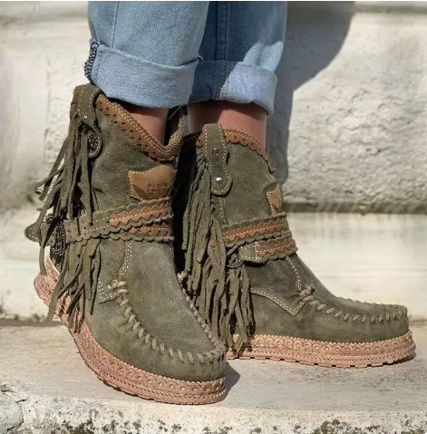 Stylish women's flat ankle boots featuring western fringe detail, ideal for boho-inspired casual outfits.