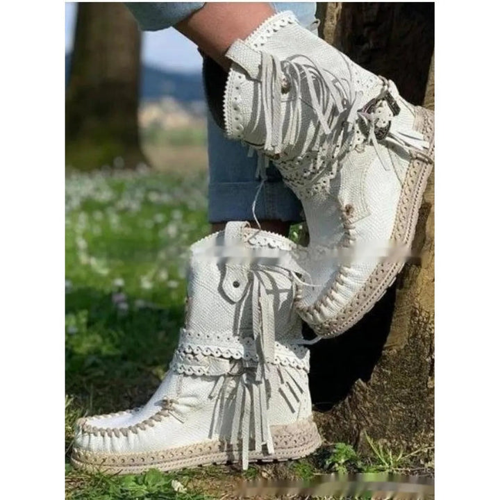 Fashionable women's ankle boots with decorative fringe, merging boho and western styles for casual appeal.