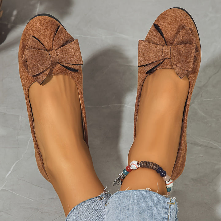 Women's comfortable everyday slip-on flats, round toe, wedge heel, and bow.