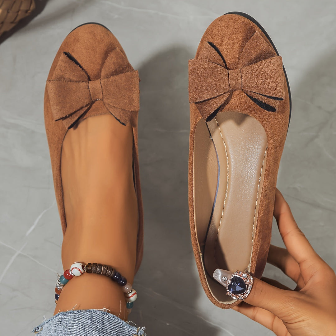 Durable women's walking wedge flats, round toe, slip-on style with bow.