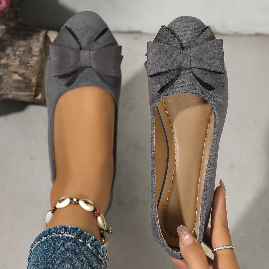 Women's office-ready slip-on wedge flats, round toe, delicate bow detail.