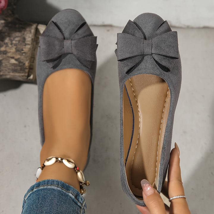 Women's office-ready slip-on wedge flats, round toe, delicate bow detail.