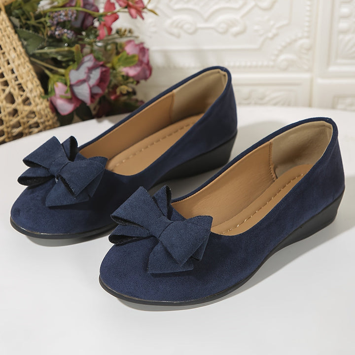 Dressy women's round toe wedge flats, slip-on with a charming bow accent.