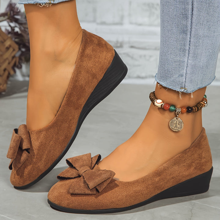 Soft leather women's bow detail wedge flats, comfortable slip-on round toe.