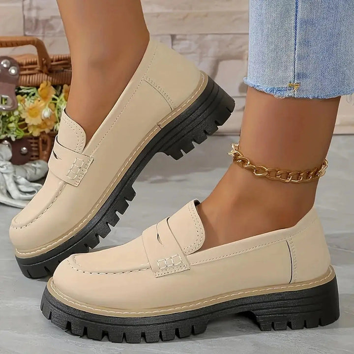 Women's black chunky platform loafers with a thick sole for modern elevated style.