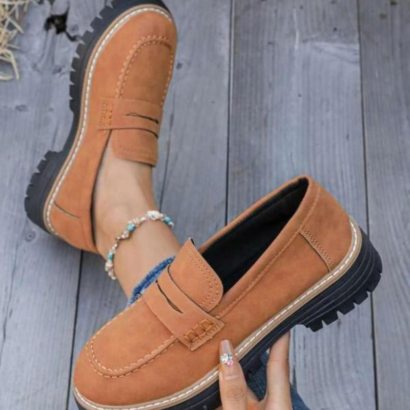 Classic black chunky platform loafers for women, offering a fashionable slip-on design.
