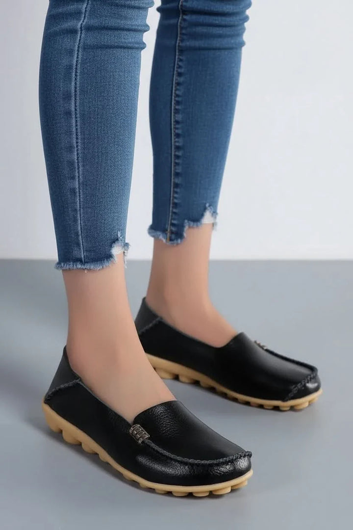 Women's black cushioned round-toe slip-on flats for all-day comfort, perfect for everyday walking shoes.