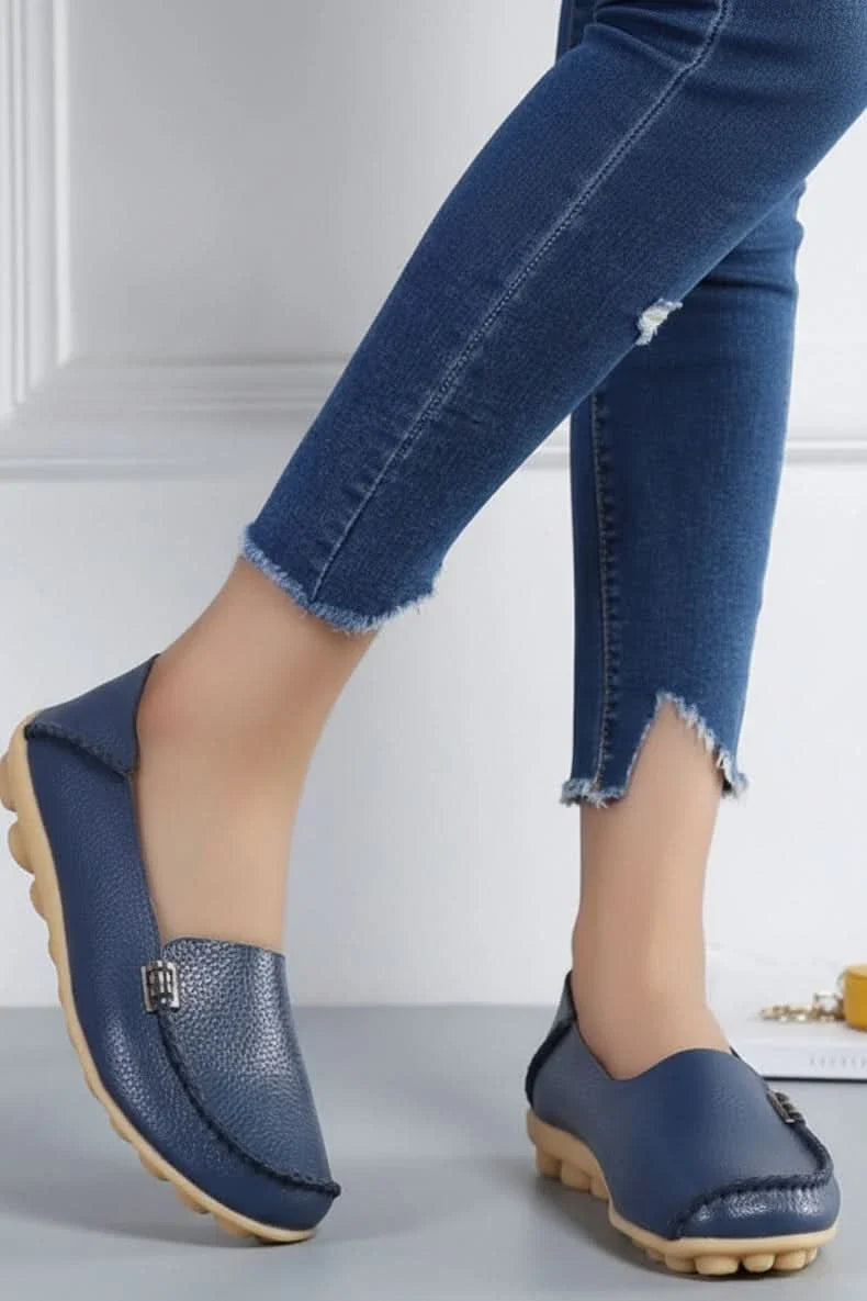 Comfortable women's navy slip-on flats, featuring a round toe & plush cushioning for walking and travel.