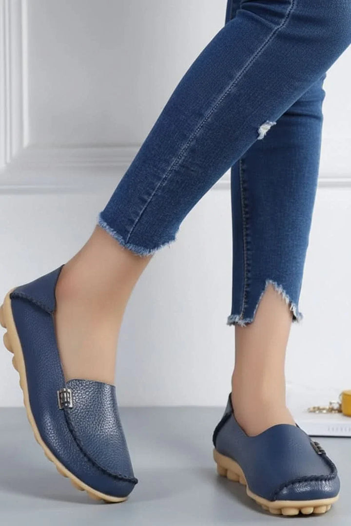 Comfortable women's navy slip-on flats, featuring a round toe & plush cushioning for walking and travel.