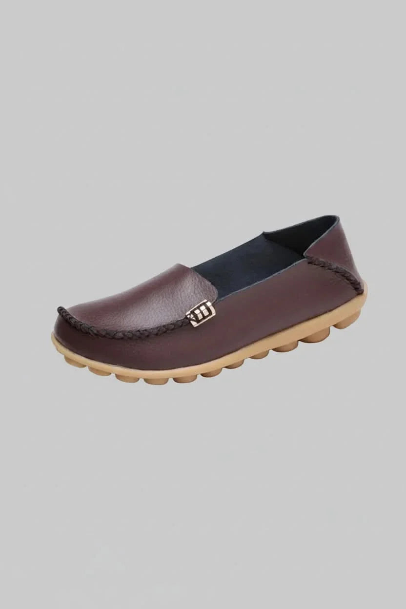 Stylish women's cushioned round-toe slip-on flats in a neutral color, great for casual, everyday wear.