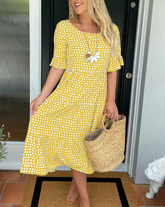 Comfortable women's flowy dotted midi dress, ideal for brunch or a relaxed summer day, featuring an elegant tiered design.