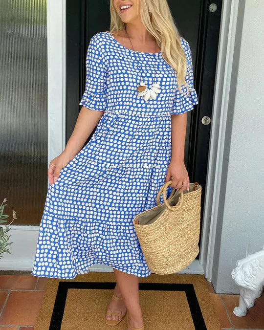 Elegant women's dotted midi dress with a comfortable relaxed fit and stylish tiered flowy design, great for any occasion.