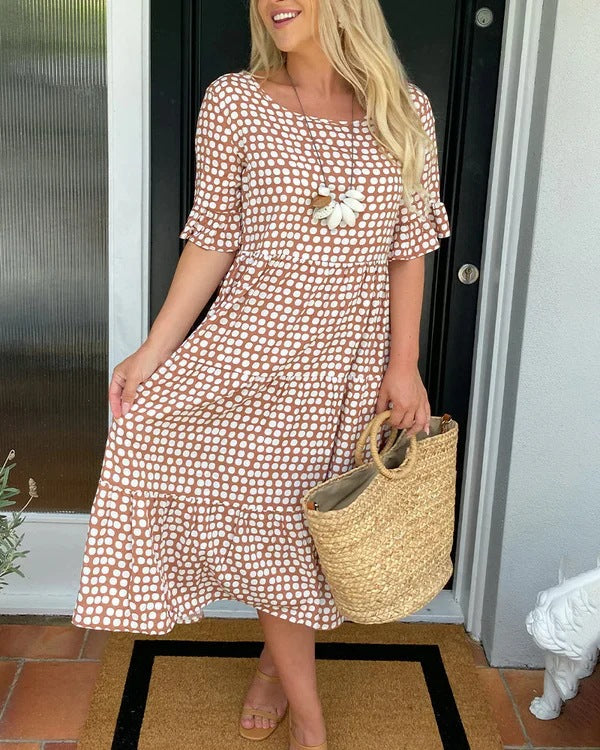 Stylish women's dotted midi summer dress, featuring a comfortable relaxed fit and beautiful flowy tiered silhouette.