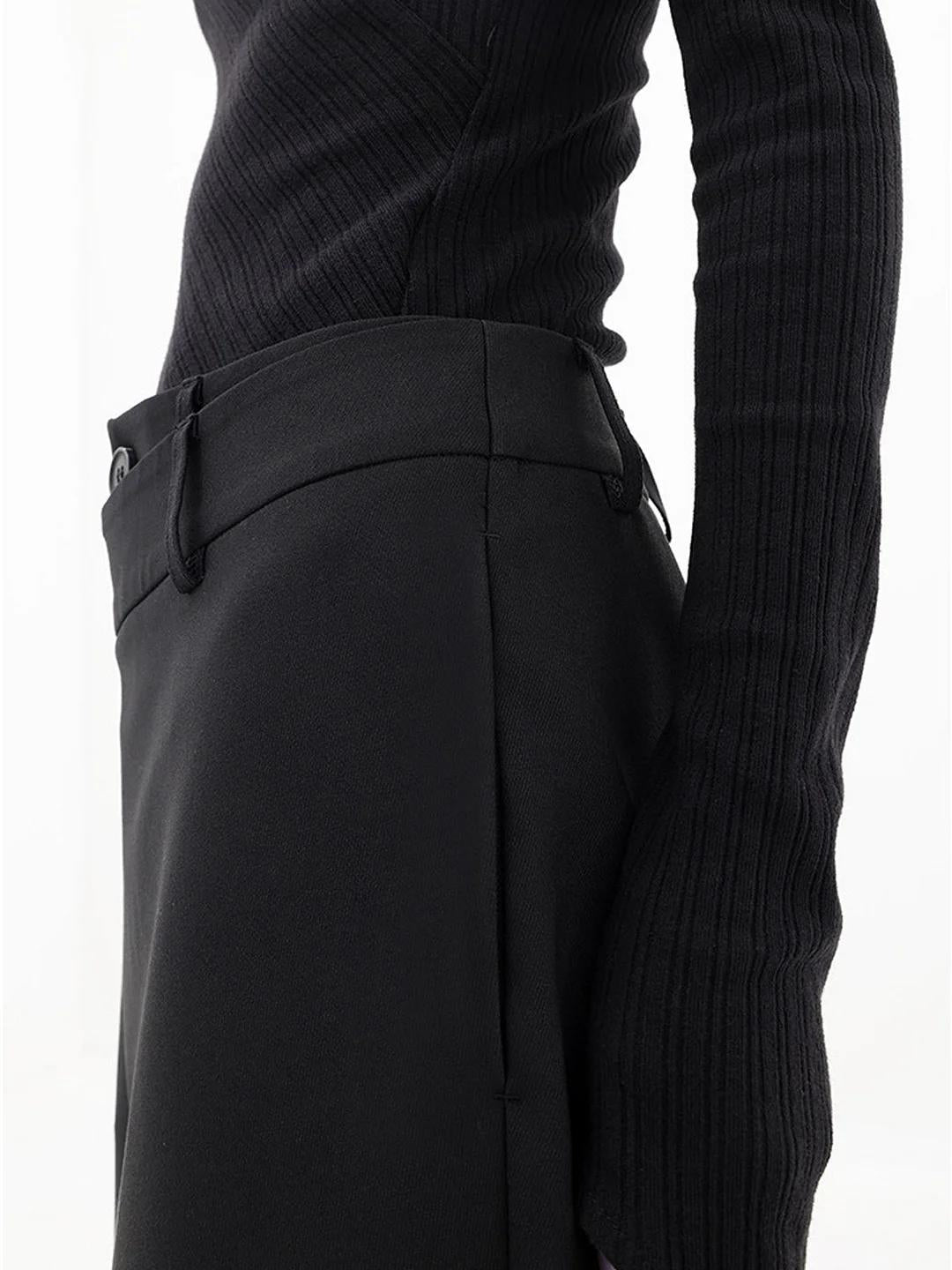 Close-up of asymmetric waist on women's black Monroe Baggy Trousers, featuring a relaxed wide leg fit.