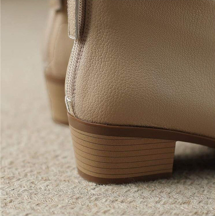 Stylish women's pointed toe slip-on ankle boots worn for office and professional everyday fashion.