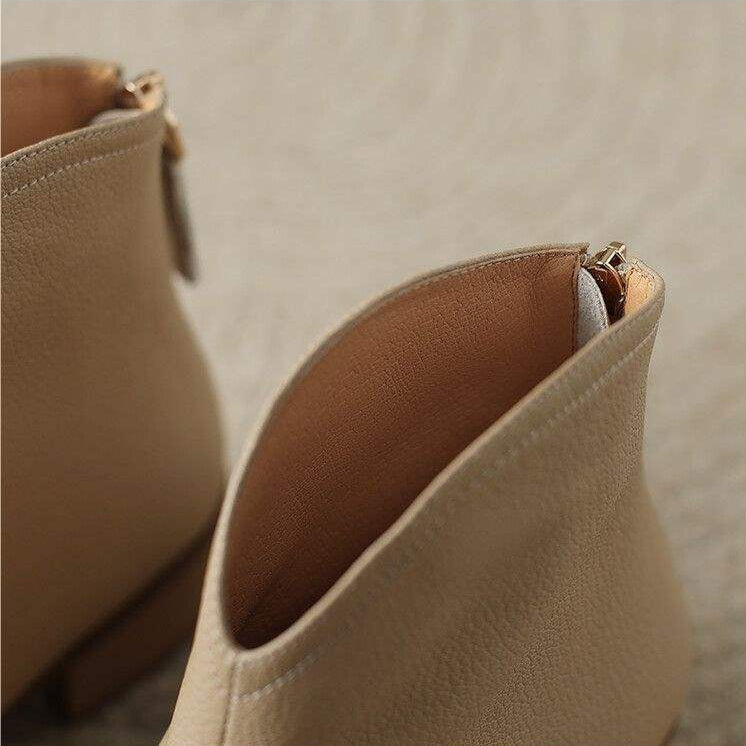 Classic women's pointed toe ankle boots with a low heel and convenient slip-on design, ultimate office footwear.