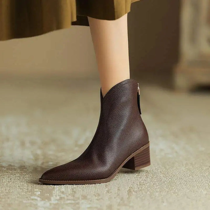 Easy slip-on women's ankle boots with a comfortable low heel & stylish pointed toe, ideal for office.