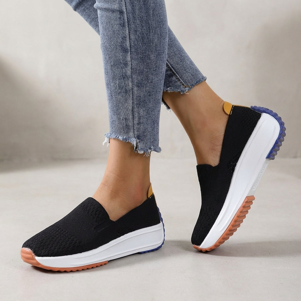 Women's black slip-on platform sneakers with orthopedic support for all-day comfort & casual walking.