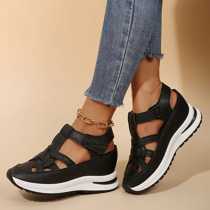Black women's sporty platform sandals, designed for all-day comfort with secure adjustable straps and a light sole.