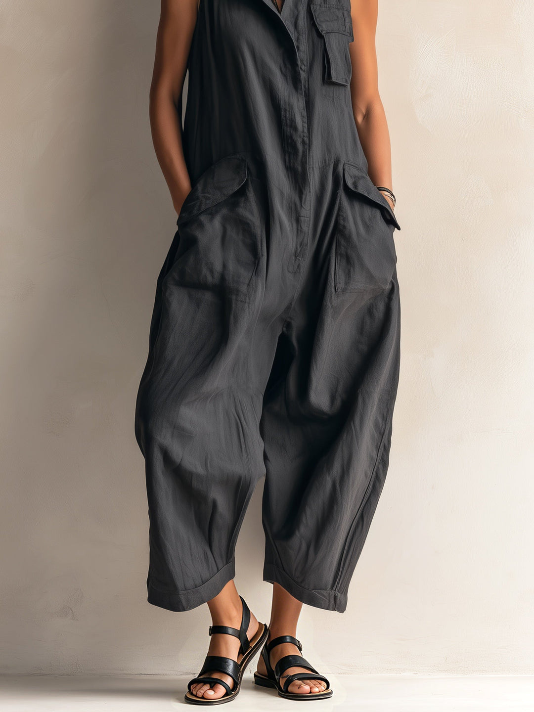 Modern women's black wide-leg jumpsuit, sleeveless with a stylish collar, perfect for casual or dressed-up looks.