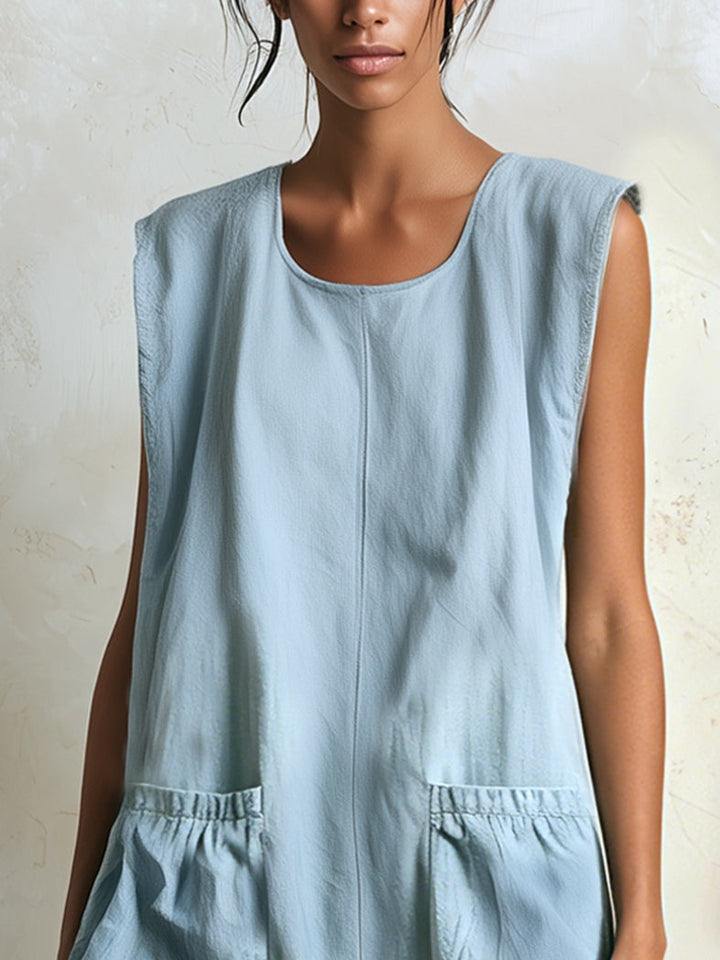 Women's sleeveless blue mini dress, with tiered ruffles & a distinctive contrast hemline. Summer apparel.
