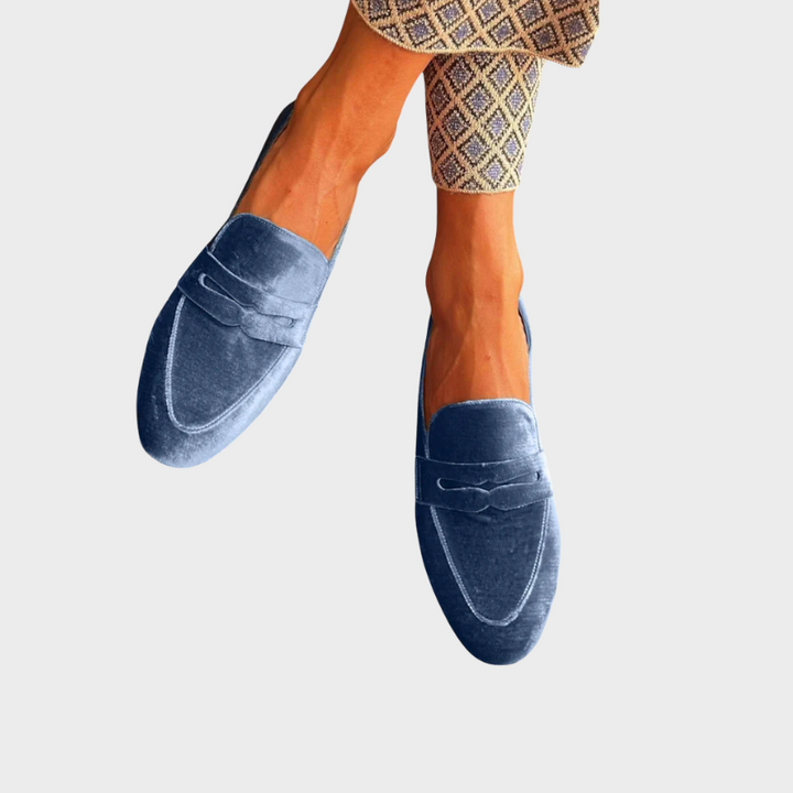 Women's blue slip-on loafers, offering effortless all-day comfort and versatile style for everyday wear.