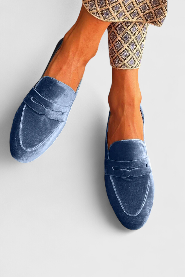 Classic blue slip-on loafers for women, perfect for comfortable casual outfits or chic office attire.