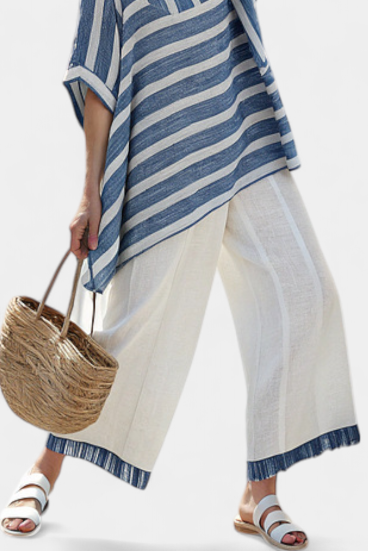Chic women's striped asymmetric batwing top & wide leg pant set. Ideal two-piece resort wear for summer fashion.
