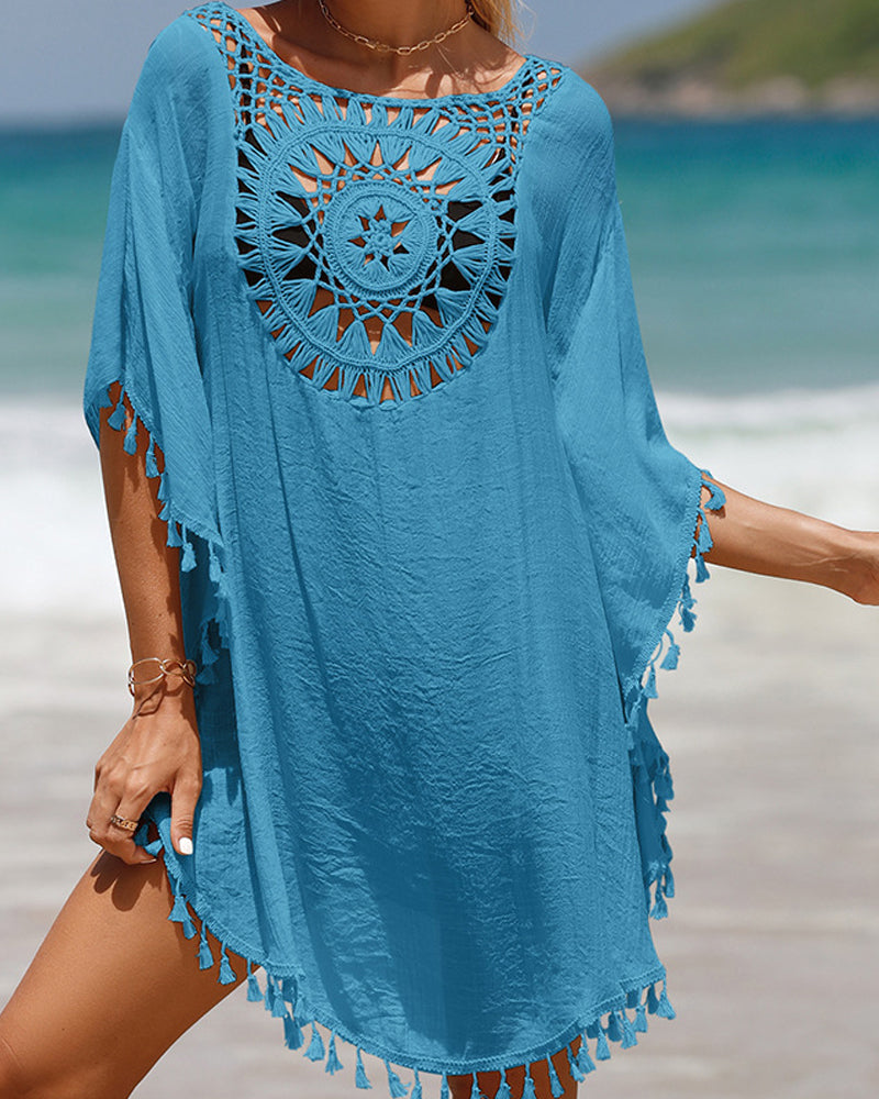 Loose fit women's swimwear cover-up with intricate tassel details, offering chic bohemian resort wear style.