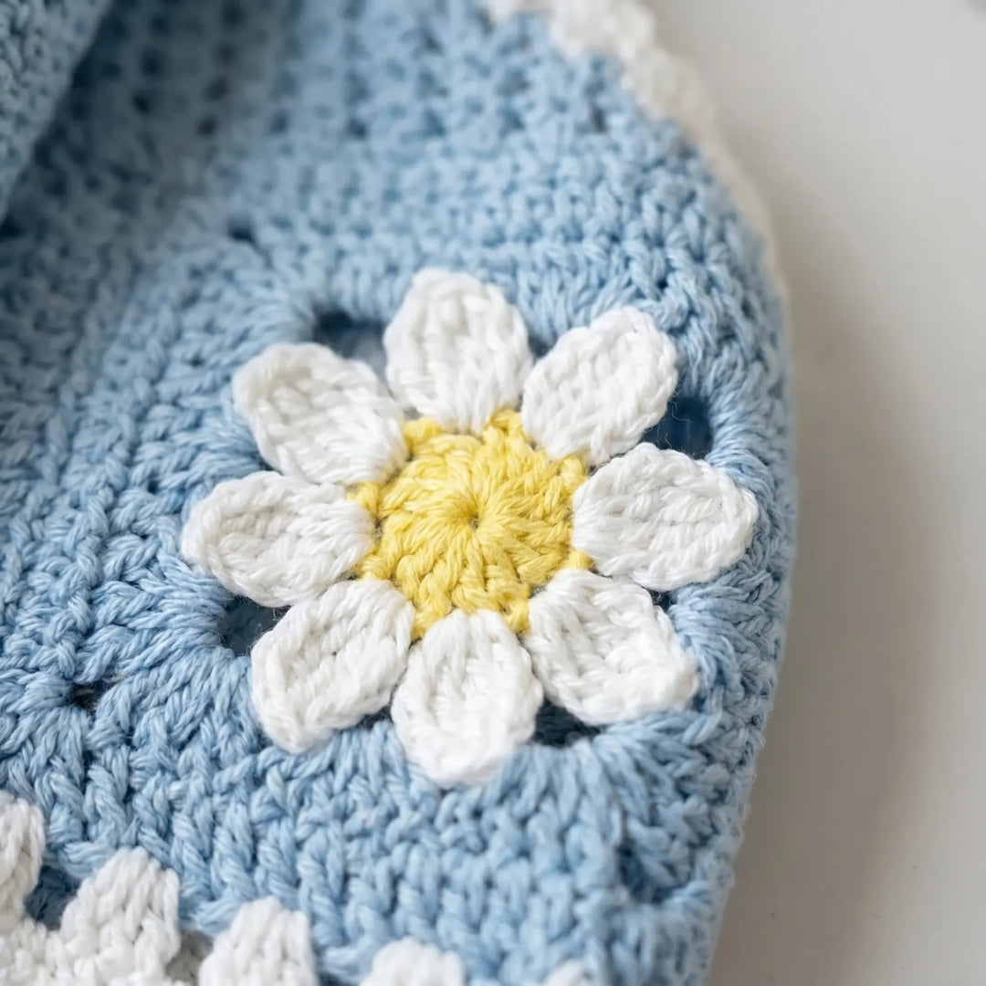 Elegant women's crochet halter crop top featuring a delicate floral pattern, great for beach & summer.