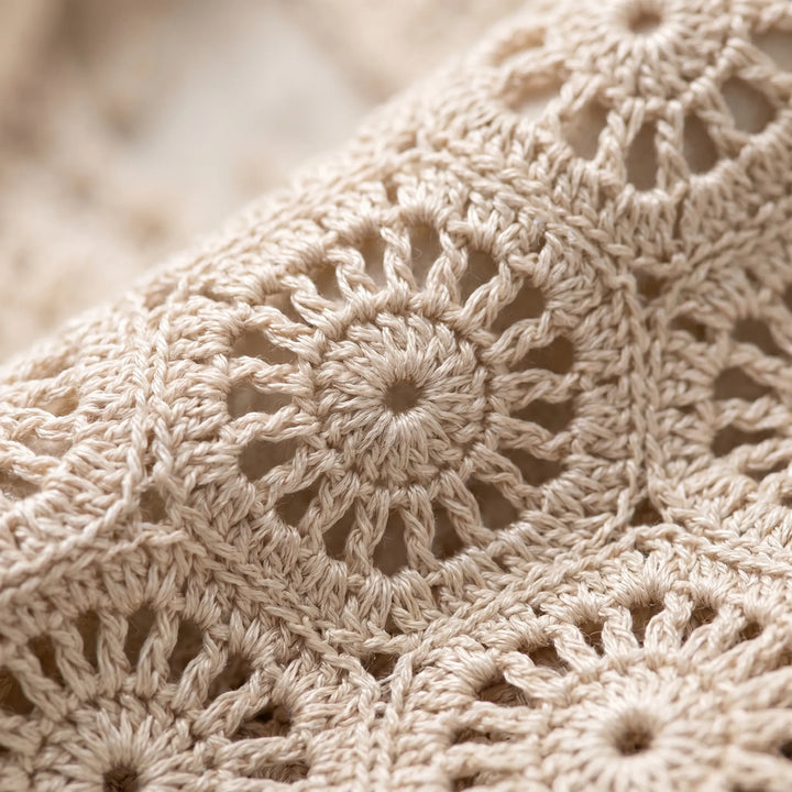 White open knit crochet crop top for women. Boho sleeveless design, great for summer fashion & festival wear.